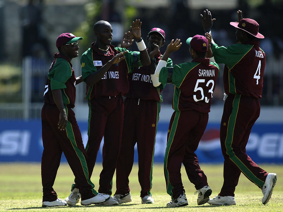 The West Indies players celebrate a wicket Photograph by Clive Mason