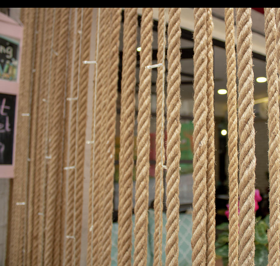 Thick ropes hanging from above in vertical shape. Decorative purpose is  placed in front of the cafe. T by Caner Ciftci