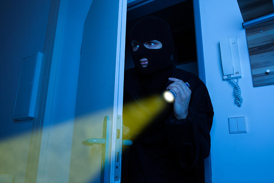 Thief Holding Flashlight While Entering Into House Photograph by AndreyPopov