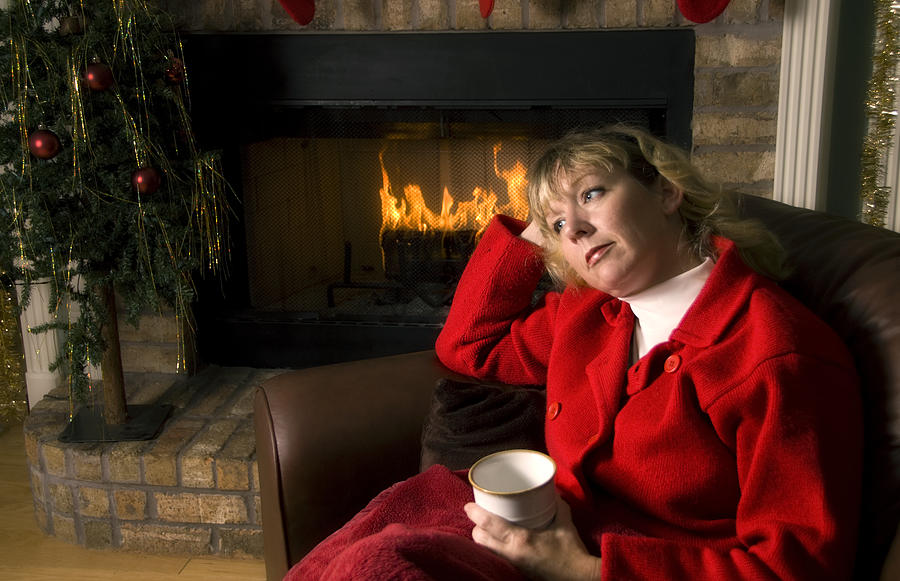Thoughtful woman by the Fireplace at Christmas Photograph by Blue_Cutler
