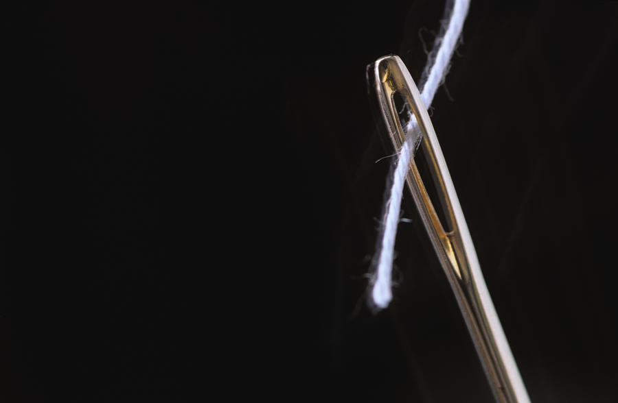 Threaded needle, extreme close up Photograph by Achim Sass