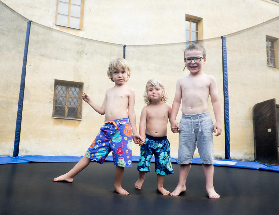 Three boys on trampoline Photograph by Jaroslav Kocian