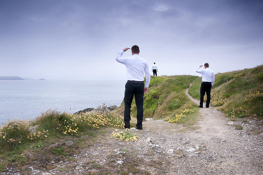 Three Businessman Looking Out Over A Clifftop Photograph by John Shepherd