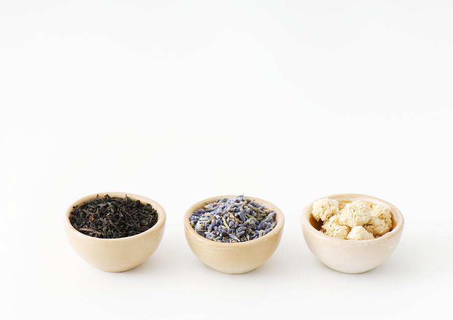 Three calabash bowls containing tea leaves, lavender, and chamomile flowers Photograph by ZenShui/Michele Constantini