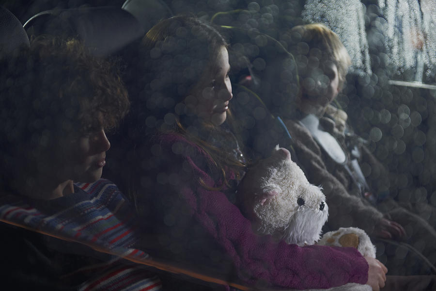 Three children in the rear seat of a car Photograph by Frank Herholdt
