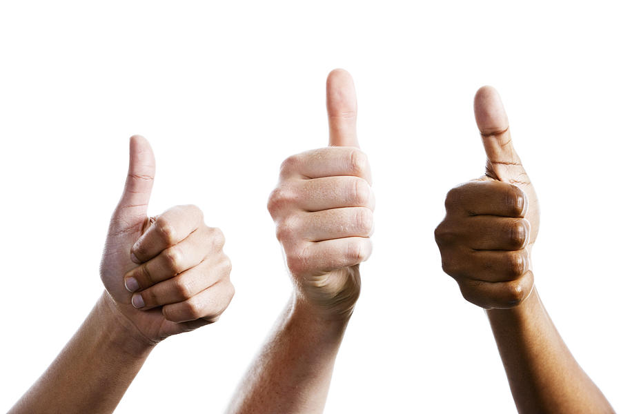 Three female hands give joint thumbs up Photograph by RapidEye