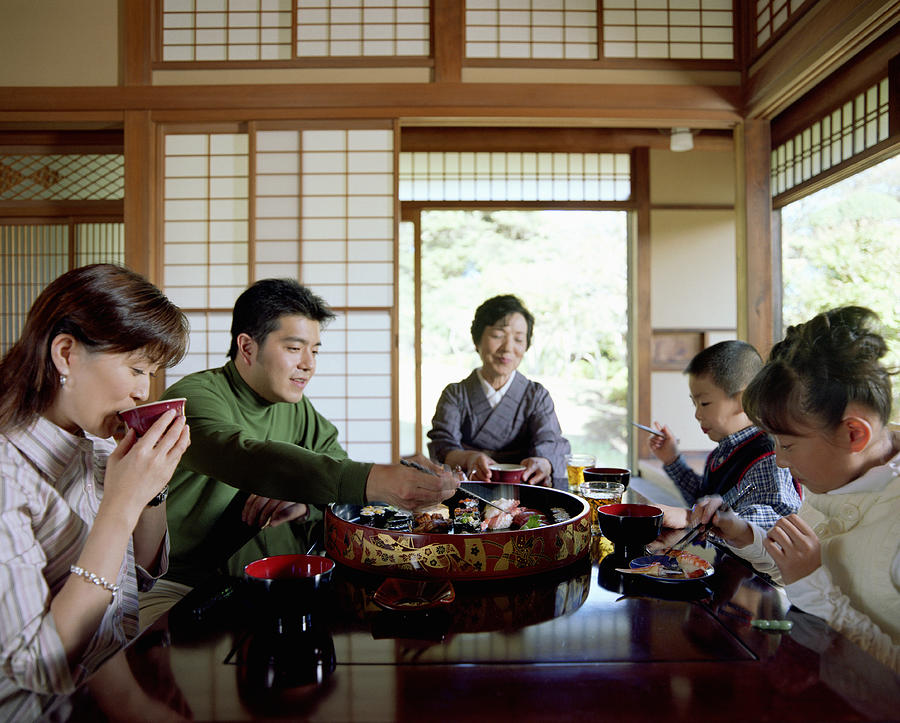 Three generation family eating sushi Photograph by LifesizeImages
