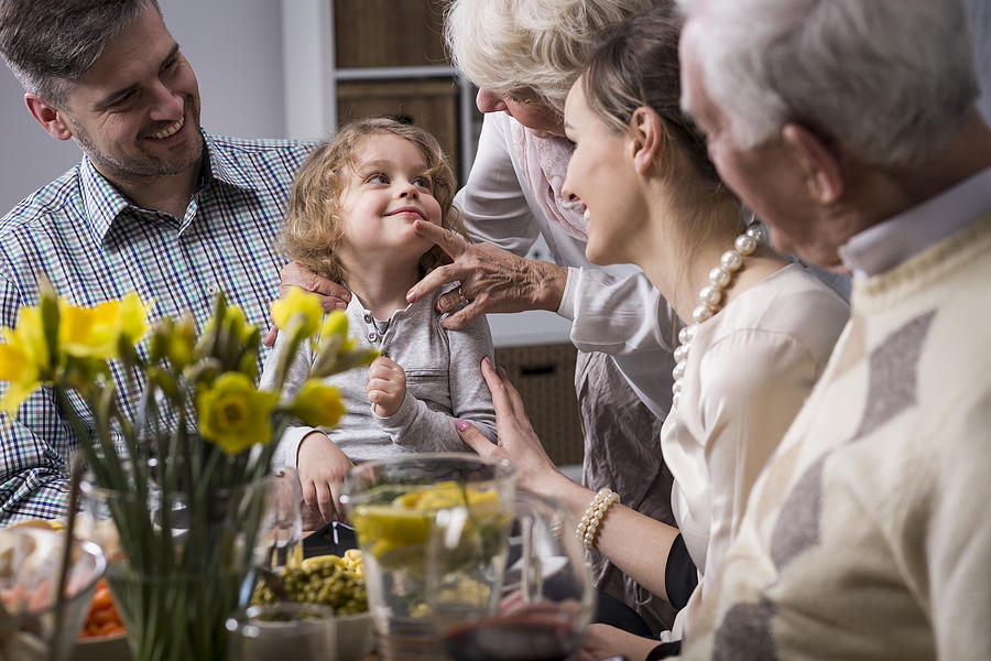 Three-generation family enjoying dinner Photograph by KatarzynaBialasiewicz