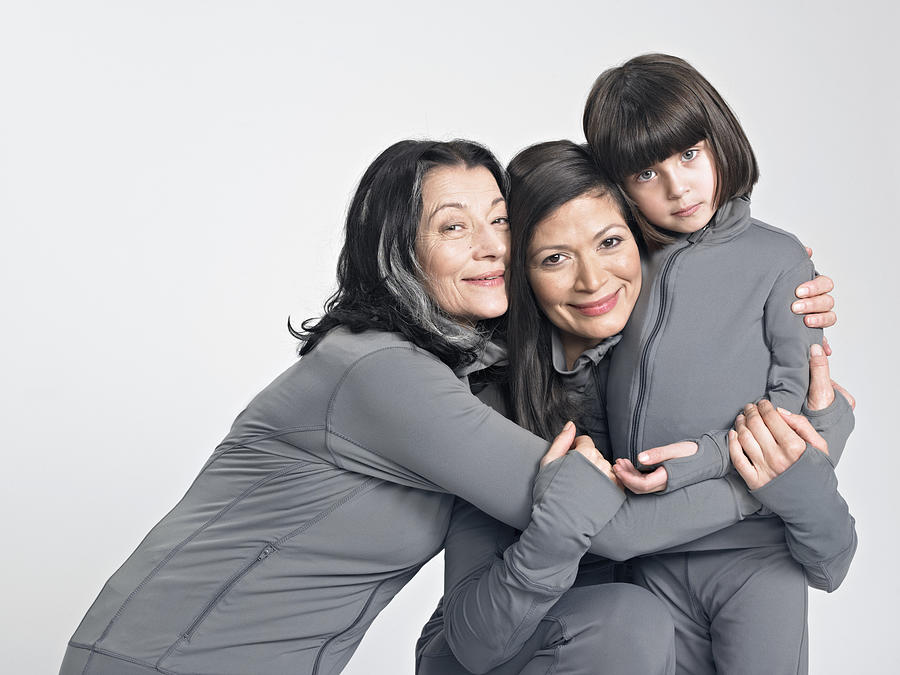 Three generations of women hugging. Photograph by Coneyl Jay