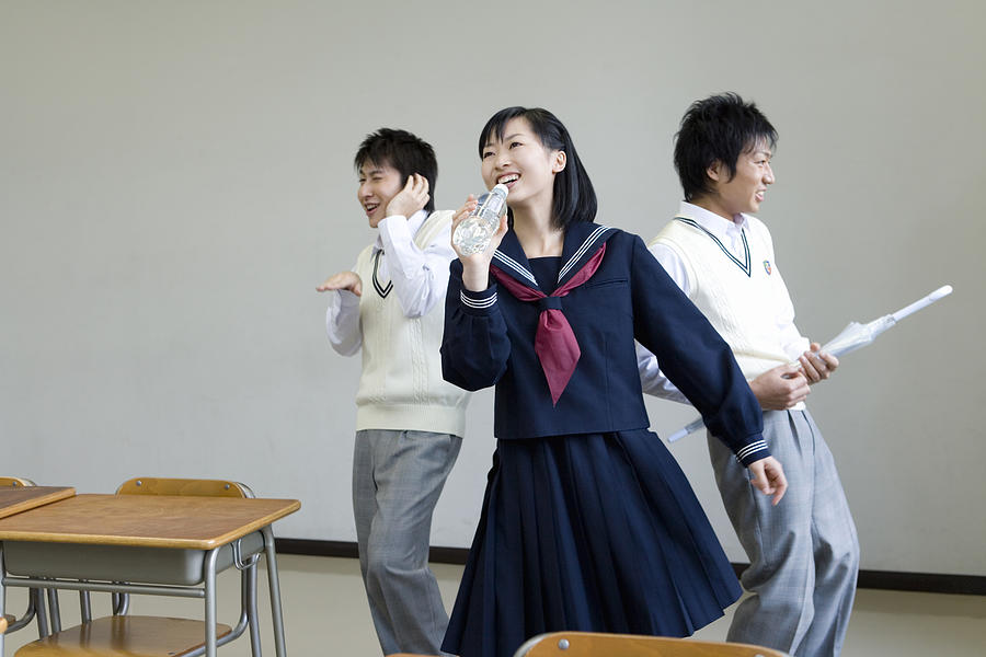 Three high school students practicing stage performance Photograph by Daj