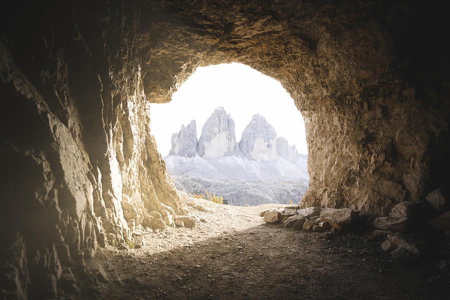 Three peaks of Lavaredo seen through a cavern entrance, Italy Photograph by © Marco Bottigelli