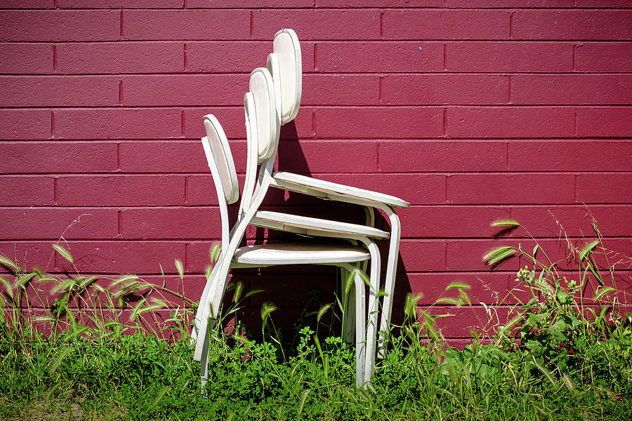Three White Chairs and a Red Brick Wall Photograph by Mary Lee Dereske