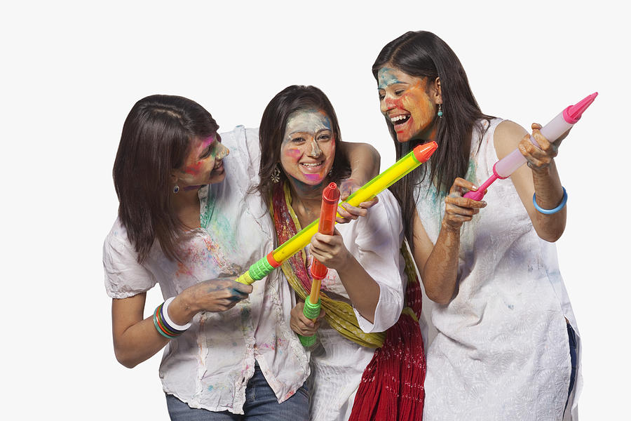 Three women playing holi Photograph by Hemant Mehta