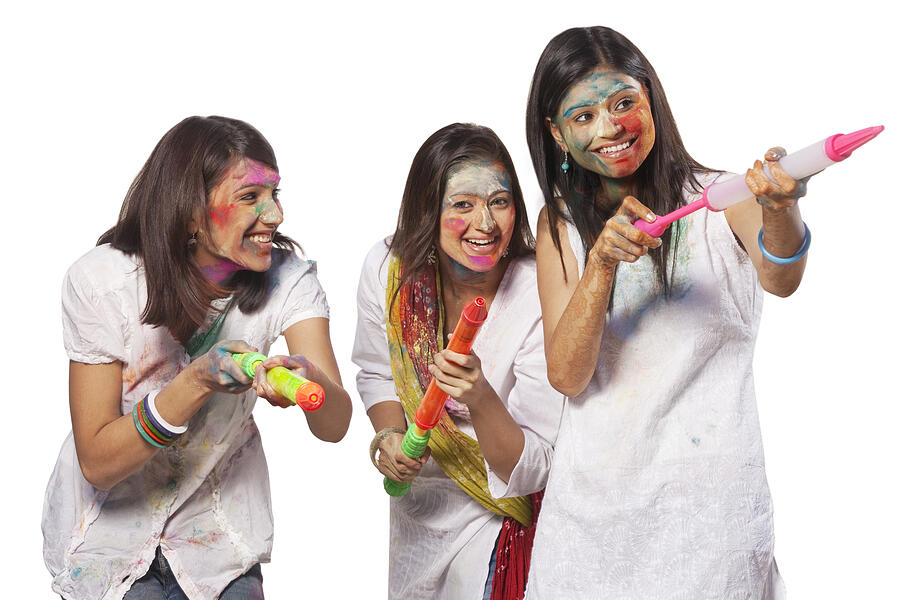 Three women playing holi Photograph by IndiaPix/IndiaPicture
