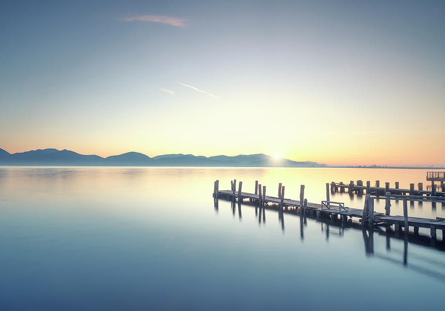 Three Wooden piers or jetties at sunrise. Torre del Lago Puccini Photograph by Stefano Orazzini