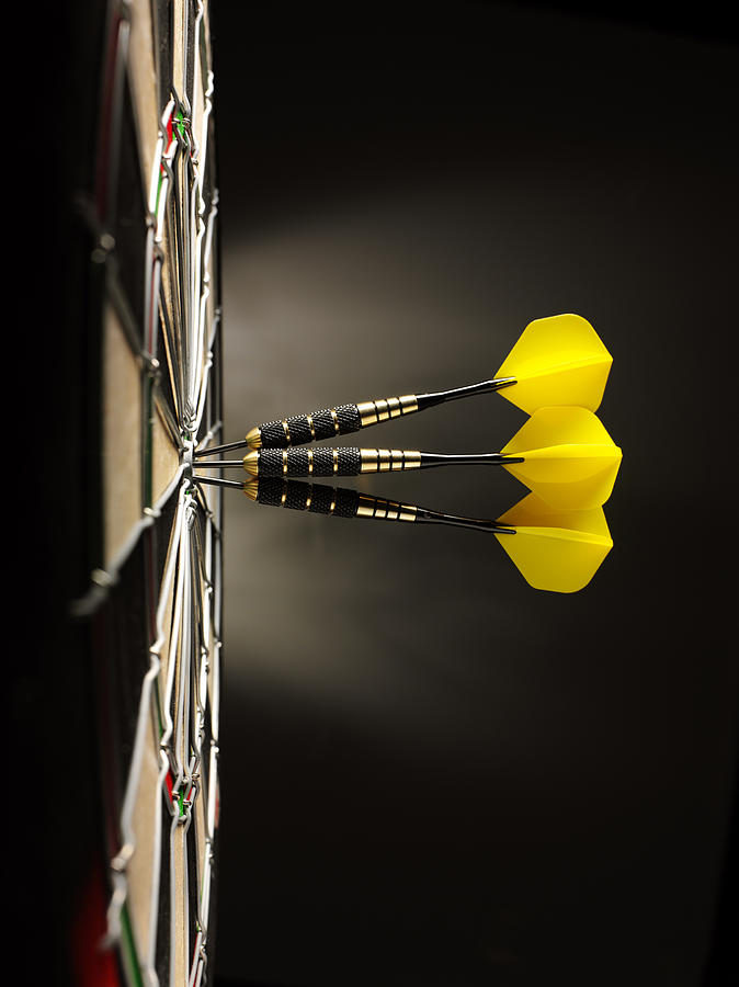 Three Yellow Darts in a Dartboard Photograph by Wragg