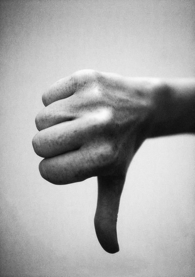 Thumb pointing down, close-up, b&w Photograph by Laurent Hamels