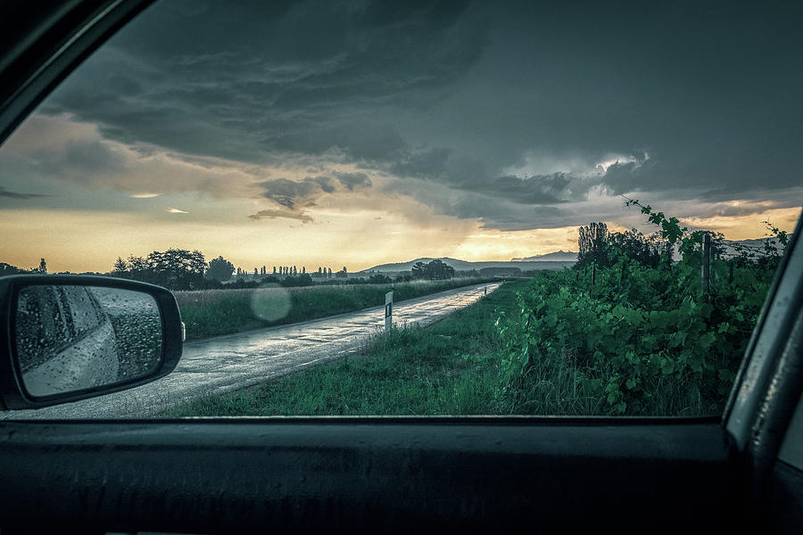 Thunderstorm on a country road Photograph by Benoit Bruchez