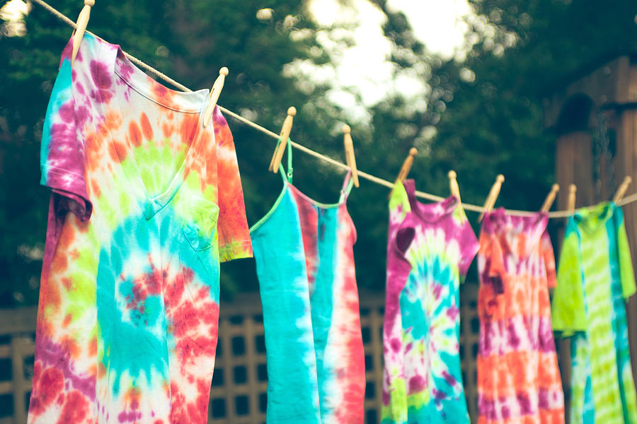Tie dyed tee shirts hanging from a clothes line. Photograph by Melissa Ross