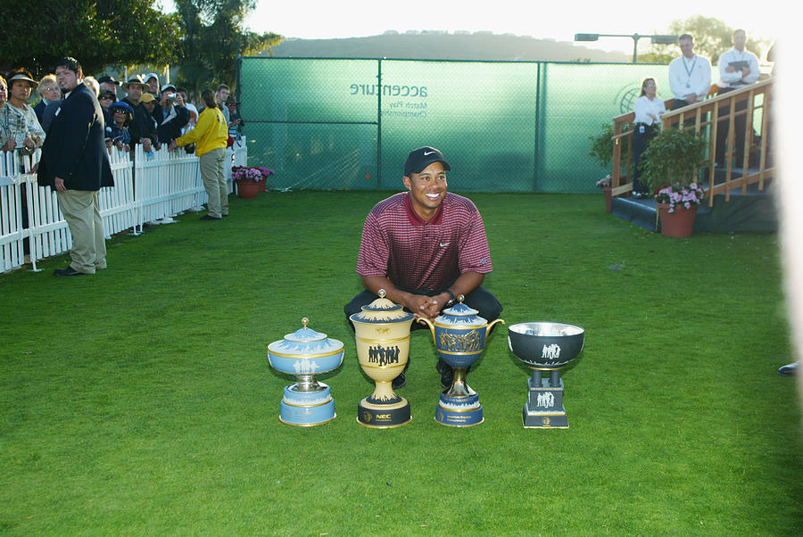 Tiger Woods poses with all four World Golf Championship trophies Photograph by Scott Halleran
