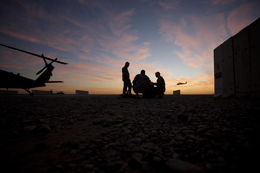 Tikrit, Iraq - A UH-60 Black Hawk crew carry out a mission brief at sunset. Photograph by Stocktrek Images
