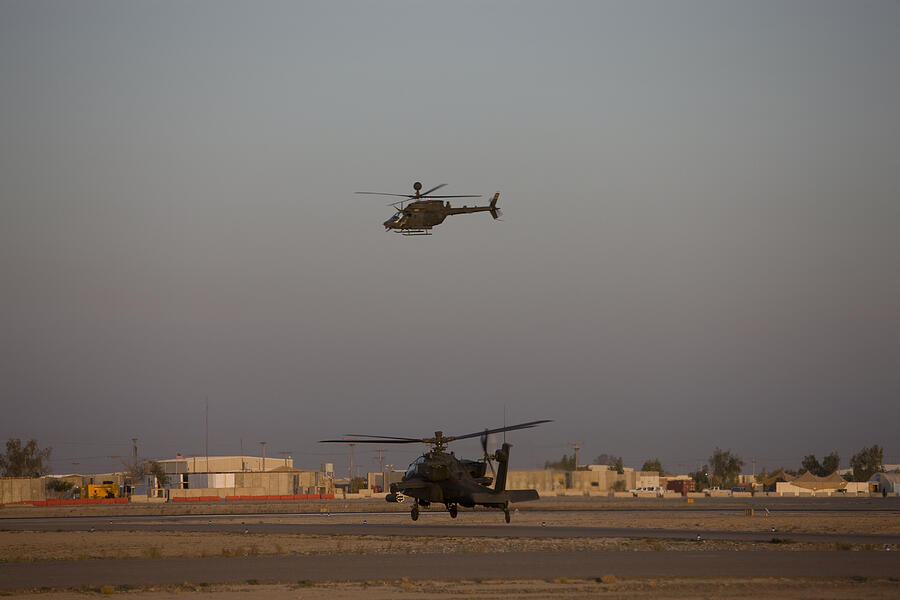Tikrit, Iraq - An AH-64 Apache Helicopter waits for a OH-58 Kiowa to clear his flight space. Photograph by Stocktrek Images