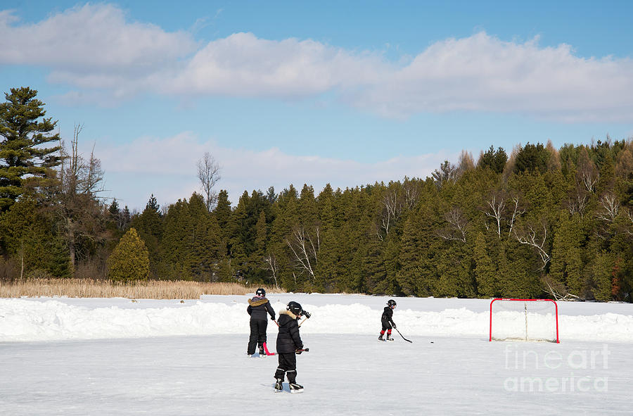Tiny Ice Hockey Players Photograph