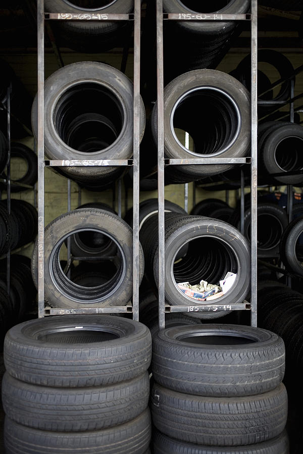Tires stacked on shelves Photograph by Michael Wells