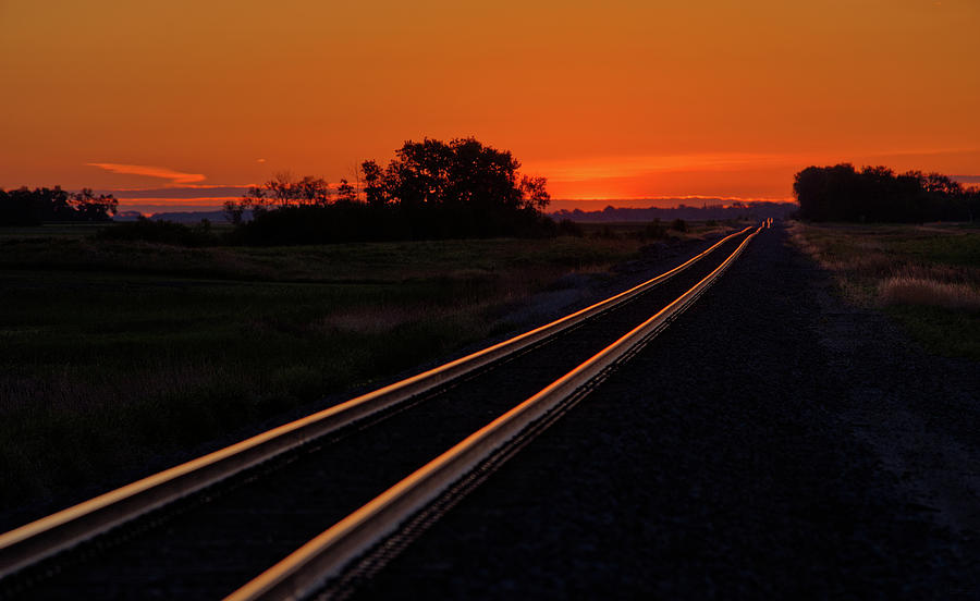 To Infinity and Beyond, Next Stop Churchs Ferry - railroad tracks glowing in ND sunset light Photograph by Peter Herman