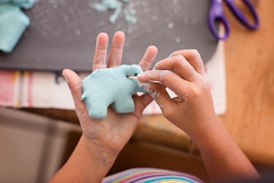 Toddler Creating Elephant From Play Doh Photograph by Laura Olivas