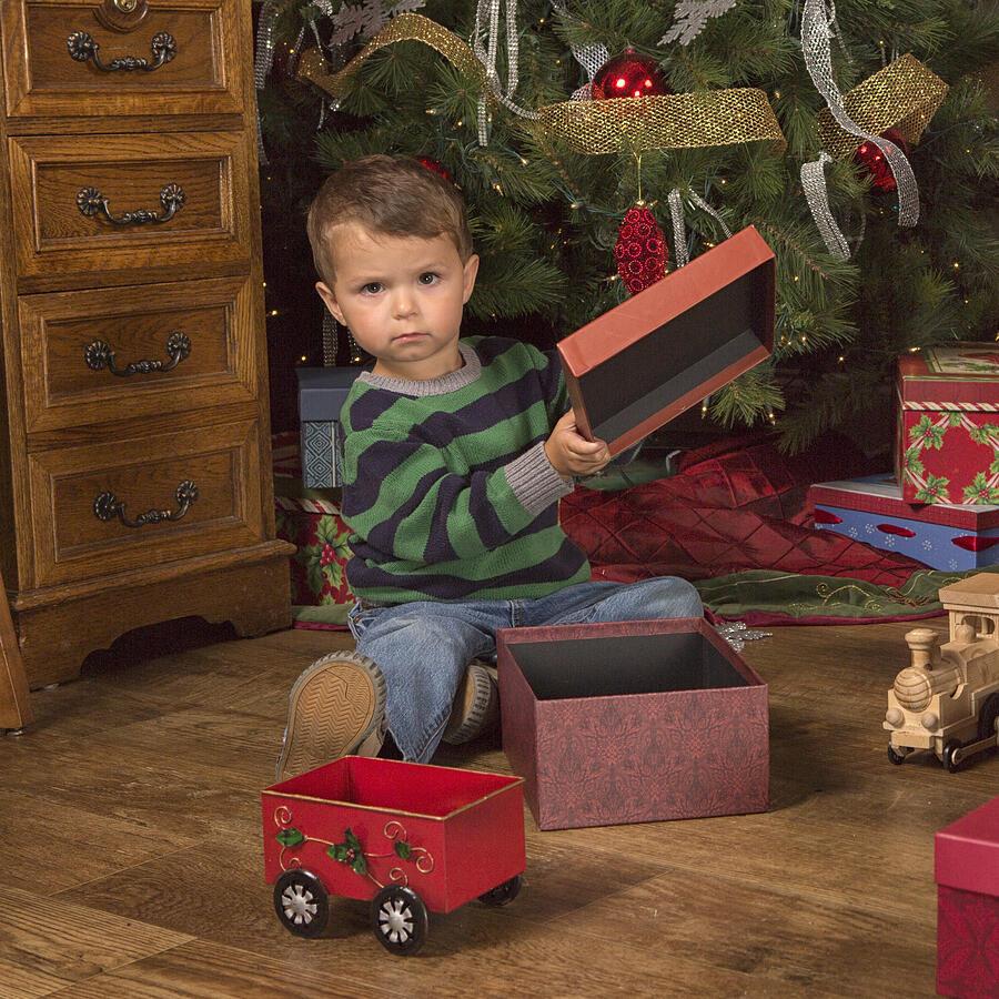 Toddler opens up an empty Christmas Gify Photograph by Inhauscreative