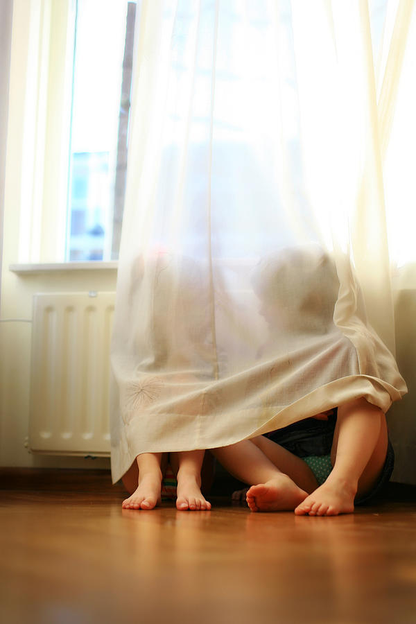 Toddlers talking behind a curtain Photograph by Heleen Zeegers