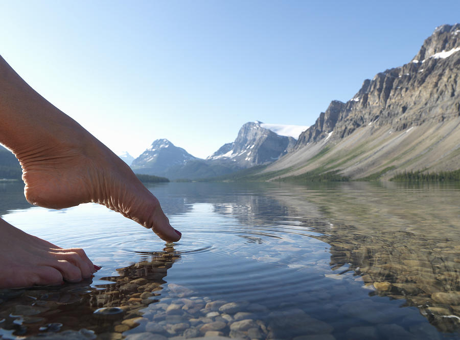 Toes touching surface of Bow Lake Photograph by Ascent/PKS Media Inc.