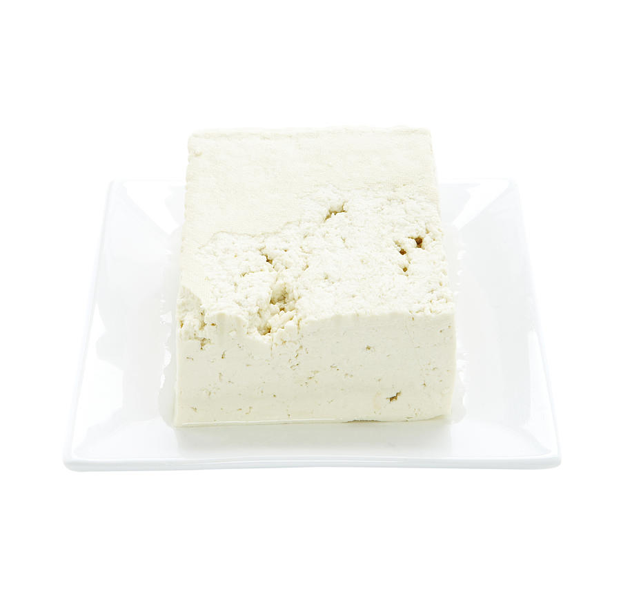 Tofu on plate on white background Photograph by Thomas Northcut