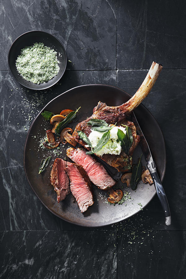 Tomahawk beef steak with mushrooms, burrata and sage Photograph by Eugene Mymrin