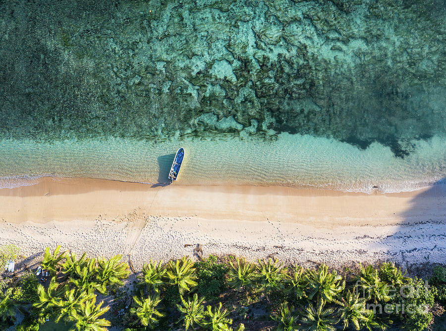 Top down view of an idyllic island with a boat a coral reef in F Photograph by Didier Marti