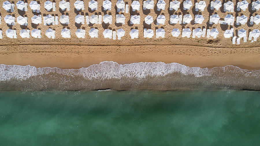 Top Down View Of Beach With White Umbrellas. Photograph