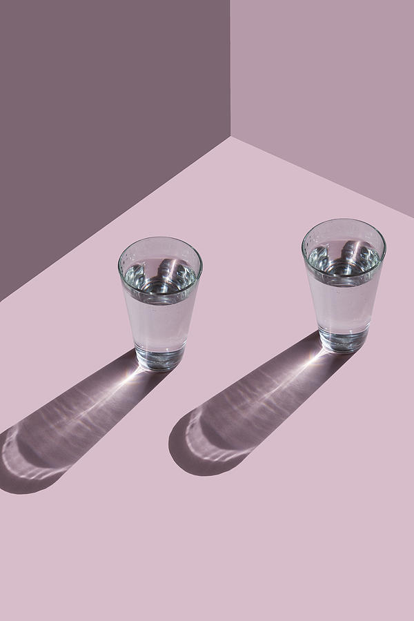 Top view of two glasses on the pink background Photograph by Yulia Reznikov