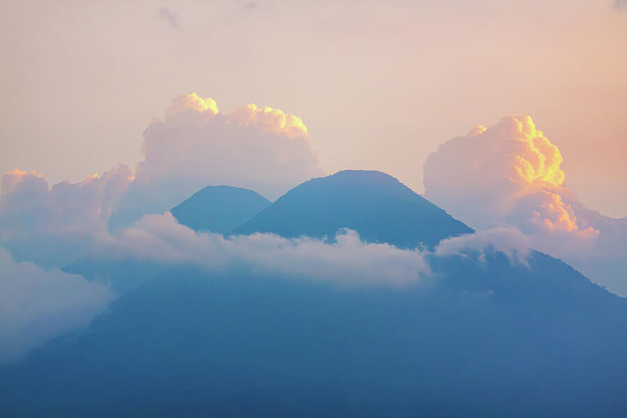 Top Volcanoes Silhouettes Framed By Clouds Photograph