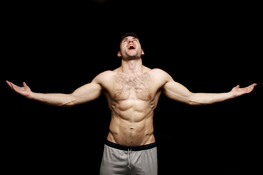Topless man shouting with his arms outstretched Photograph by Mimic51