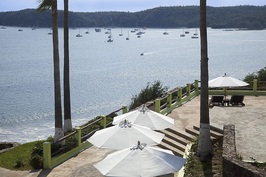 Tops of four white umbrellas on a patio overlooking boats in Tenacatita Bay; Costalegre, Jalisco, Mexico Photograph by Timothy Hearsum