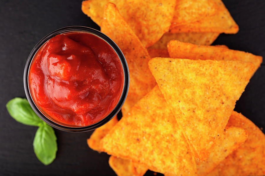 Tortilla chips and one glass bowl filled with salsa sauce Photograph by Sebastian Radu