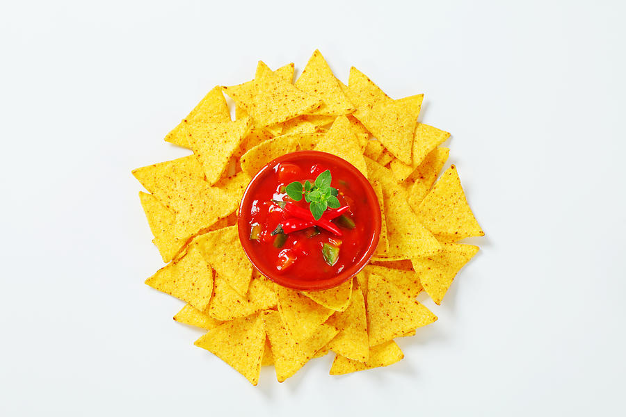 Tortilla chips with salsa souce Photograph by Milanfoto