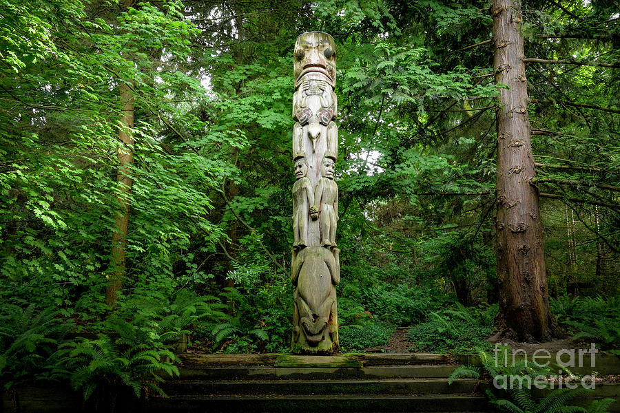 Totem Pole in forest Photograph by Michael Wheatley