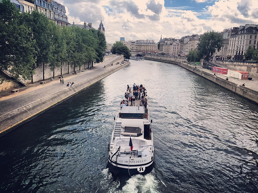 Tour boat with tourists on Seine River, Paris, France Photograph by Anouchka
