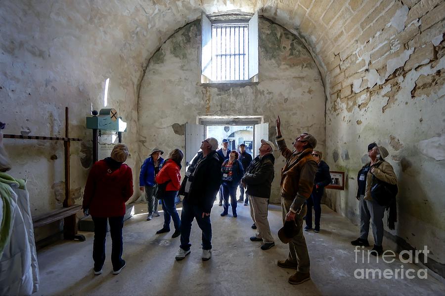 Tour group in an interior room at Castillo de San Marcos, a Spanish fortification at St. Augustine Photograph by William Kuta
