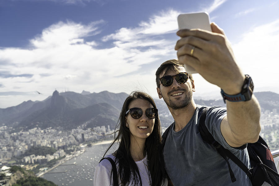 Tourist couple taking a selfie in Rio de Janeiro using a phone Photograph by FG Trade