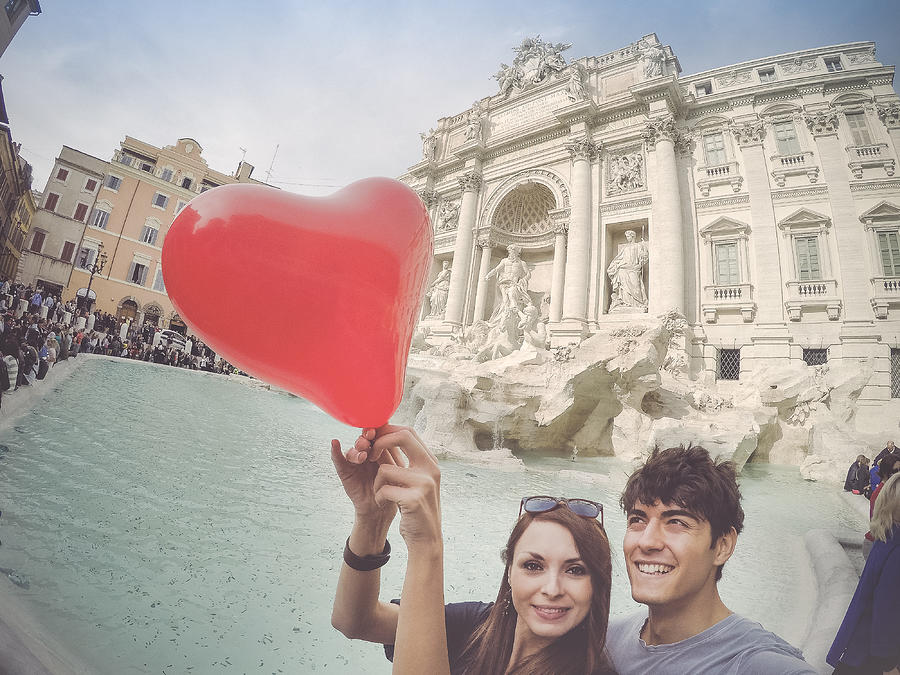 Tourist couple taking a selfie with heart at Trevi fountain Photograph by Piola666