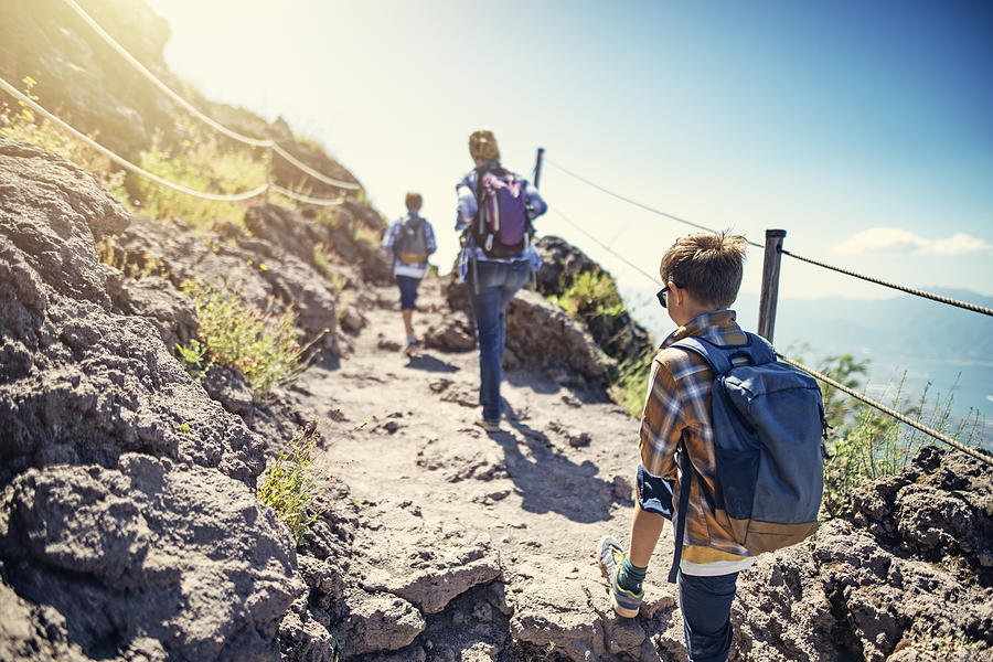 Tourist family hiking on Mount Vesuvius volcano in Campania, Italy Photograph by Imgorthand