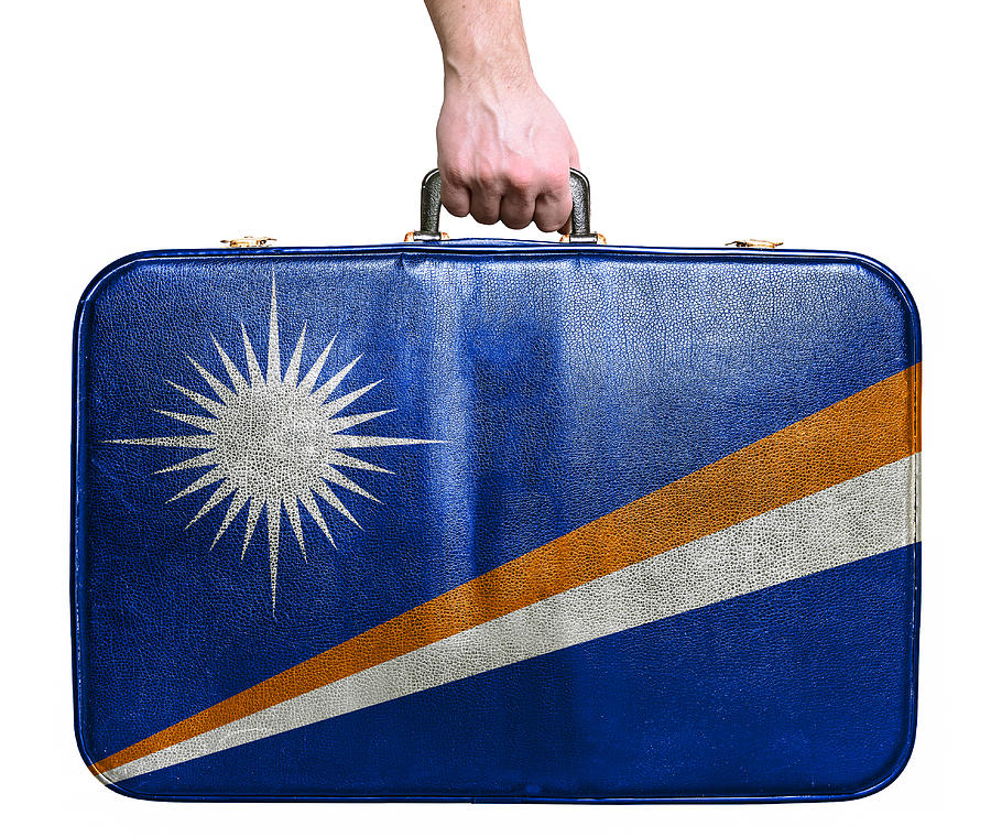 Tourist hand holding vintage travel bag flag of Marshall Islands Photograph by Alexis84